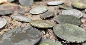 Archaeologists find ancient treasures near grave of WWII soldier