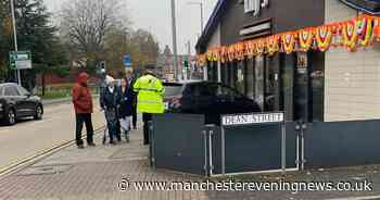 Woman injured as car crashes into Indian restaurant