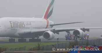 Fire crews surround Emirates plane on runway at Manchester Airport after 'loud bang'