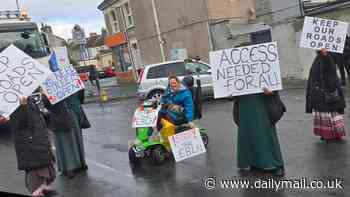 Families form human shields to stop workmen installing planters to create Low traffic Neighbourhood on their street