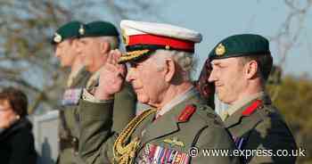 King Charles looks dapper as he returns to Royal Marine centre where he trained as pilot