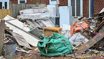 Man who turned front garden into a makeshift tip with tonnes of rubbish is KICKED OUT of his home by council after neighbour complained it made their children sick