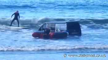 That'll flood the engine! Driver gets sinking feeling when his Ford Transit gets submerged by incoming tide after getting stuck on the beach