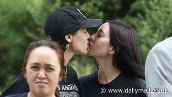 The Veronicas singer Jess Origliasso shares a sweet smooch with fiancée Alex Smith at Sydney Airport as the couple arrive in Australia