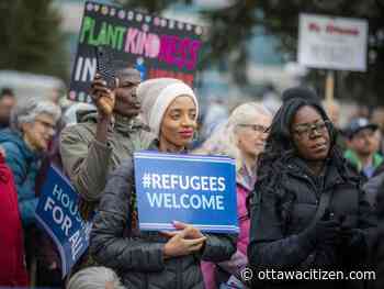 Residents rally to support city's planned reception centres for newcomers while others protest