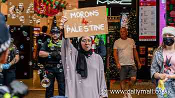 Unmasked - the nose-ringed protester who tried to ruin Myer's Christmas window display for Aussie kids... as Melbourne woman reveals why her true identity is a secret