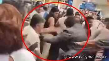 Wild moment huge brawl breaks out as dozens of bargain hunters fight over discounted TVs in Walmart