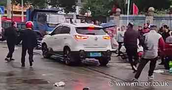 China car crash horror as driver ploughs SUV into crowds outside primary school