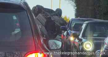 Road blocked as car overturns on busy Bradford route