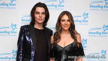 Elizabeth Hurley wows in a glamorous black gown with a daring thigh-high split as she joins son Damian at the Shooting Star Ball