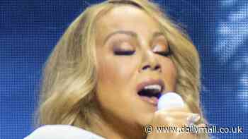 Mariah Carey dazzles in sparkly white gown as she performs during her Christmas Time tour in Atlanta