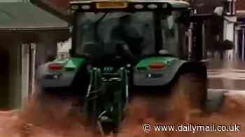 Moment tractor driver sends wave of Storm Bert floodwater smashing through shop windows as he speeds through Worcestershire street - leaving locals furious