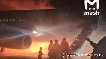 Terrifying moment plane goes up in flames after nightmare landing which saw dozens of passengers and young children forced to evacuate on the tarmac at Turkey airport