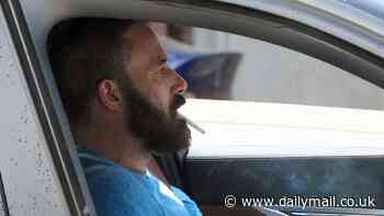 Ben Affleck smokes cigarette and rocks a bushy beard while driving in Los Angeles