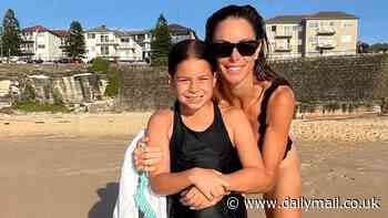 Candice Warner shows off her weight loss in a V-neck swimsuit as she hits the beach with her daughters in Sydney