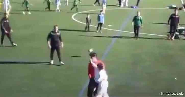 Shocking moment mother storms pitch and SLAPS referee during under-12 football match