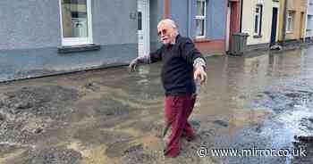 UK floods: Terrified residents forced to flee homes after massive landslide buries street