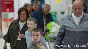 Coleen Rooney's youngest children Kit, seven, and Cass, six, clutch Wayne figurine as they jet to Australia with their grandparents for an emotional reunion