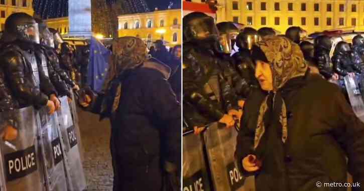 Brave elderly woman scolds shielded police while water canons are unleashed on protesters