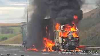 Moment firefighters battle raging inferno after lorry full of sawdust bursts into flames on the M62 - sparking huge traffic jam