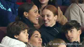 Jess Glynne looks lovingly at her girlfriend Alex Scott as the couple enjoy football match at Emirates Stadium