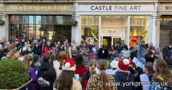 Pupils sing Christmas songs to shoppers in St Helen's Square