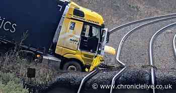 Train disruption and one person in hospital after lorry crashes on to railway line