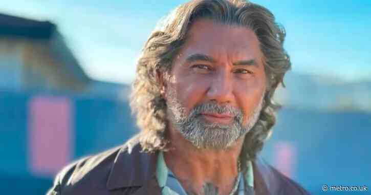 Hollywood muscleman unrecognisable with long grey hair and beard