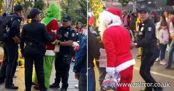 Moment 'Santa Claus' and 'Grinch' arrested after street brawl breaks out over tips