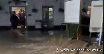 Dramatic footage shows swollen river turn into waterfall outside pub and homes