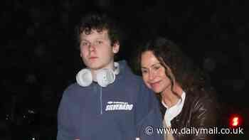 Minnie Driver proudly embraces her rarely-seen son Henry, 16, as they leave dinner in Santa Monica