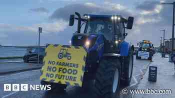 Farmers drive through city to protest tax changes