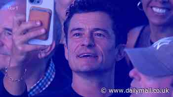 Orlando Bloom proves he is fiancée Katy Perry's number one fan as he films her on his phone while front row at her ITV concert special as viewers call them 'couple goals'