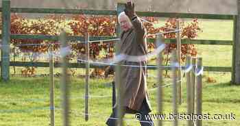 King Charles III pictured smiling and waving as he leaves church service