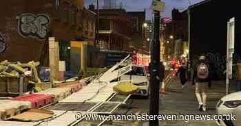 City centre road closed after barriers topple over and fall onto car