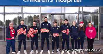 Oxford United players bring Christmas cheer to children’s hospital