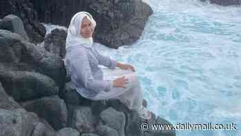 Teenager is washed away to her death while posing for a photo on rocks in Indonesia - as locals desperately try to save her