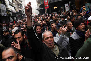 Hundreds protest in Damascus after hooded figures set Christmas tree ablaze