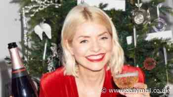 Holly Willoughby puts on a very glamourous display in a plunging red dress as she enjoys a cheeky tipple while celebrating Christmas