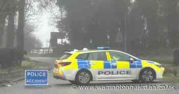 Busy road remains closed after car crashes into building and pole