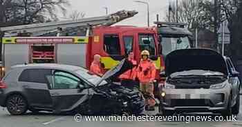 Road closed and woman injured after crash involving two cars