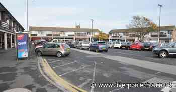 Woman hit by car next to busy square of shops