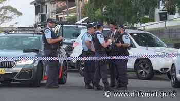 Man is shot dead in a suspected gangland hit in western Sydney - as cops hunt for the gunman and discover a burnt out car nearby