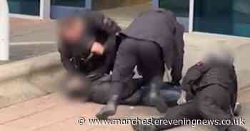 Police at Manchester Airport filmed 'kicking and punching' arrested man as he is pinned to the ground