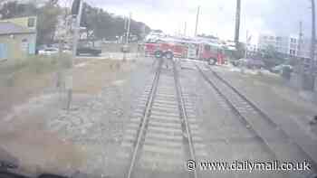 Horrifying moment high speed train struck Florida fire truck whose driver ignored barriers