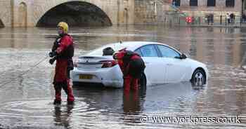 Car left parked in floodwater in York is pulled to safety by firefighters