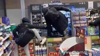 Moment brazen group of thieves leap the counter and pillage Asda petrol station in front of shocked customers