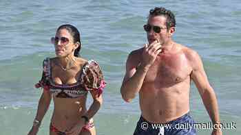 Bethenny Frankel, 54, dons puff-sleeve bikini for New Year's Day dip in Miami with boyfriend Tom Villante