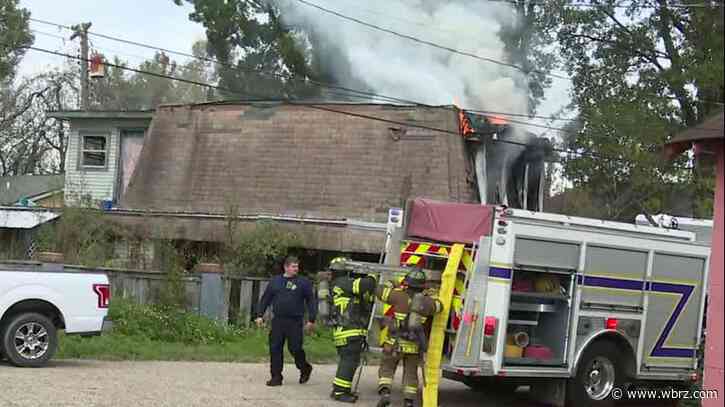 Firefighters working house fire on Cotton Street near Thomas H. Delpit Drive