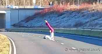 Woman spotted doing yoga in middle of major road shut due to severe flooding